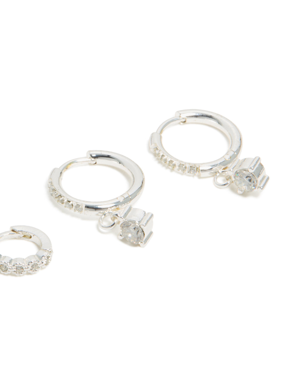 Showcasing waterproof stainless steel cubic zirconia stud and huggie earrings in a 3-pack with charm silver white detail