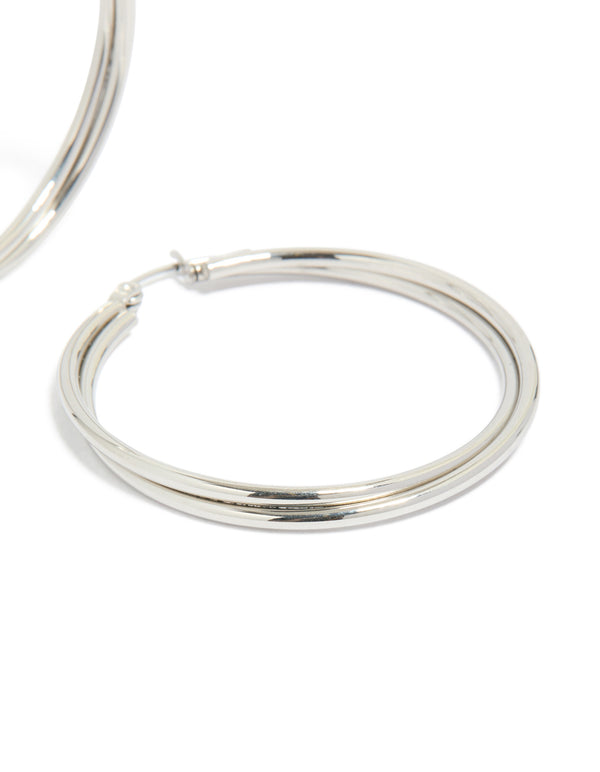Featuring surgical steel crossover hoop earrings in silver post detail view