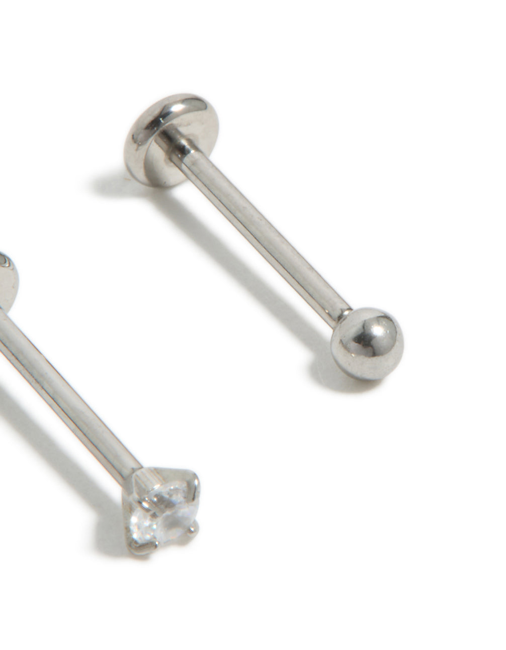 Crafted from titanium, these cubic zirconia threadless flat back nose studs feature ball accents in silver with a dainty styling detail view