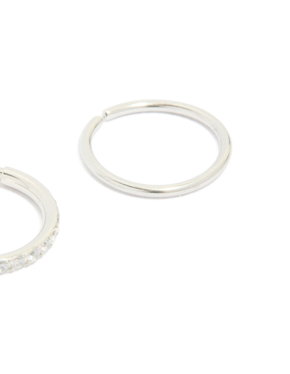 Showcasing surgical steel cubic zirconia hinged and plain nose rings in a 2-pack with diamond accents and silver finish close up view
