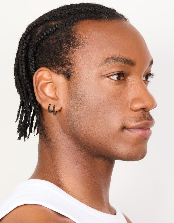 Crafted from waterproof black coated stainless steel, these mens huggie earrings come in a 2-pack on model view