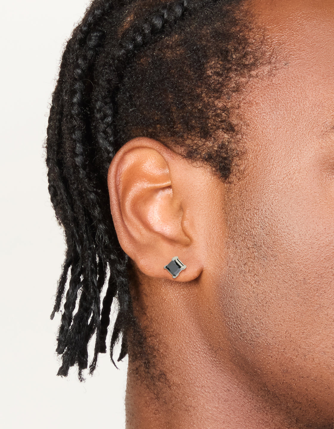 Showcasing mens waterproof stainless steel small square black cubic zirconia stud earrings on ear view