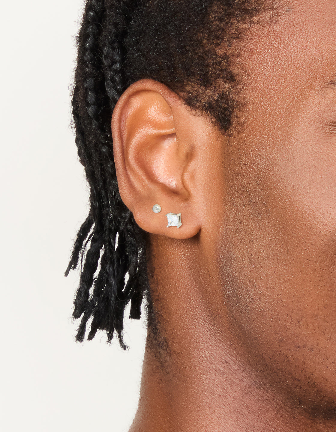 Showcasing mens waterproof stainless steel square cubic zirconia and ball earrings 2 pack on ear view
