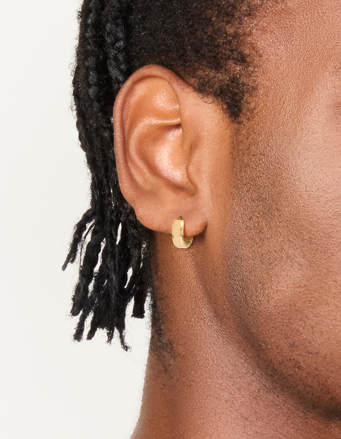 Showcasing mens waterproof gold plated stainless steel brushed huggie earrings on ear view