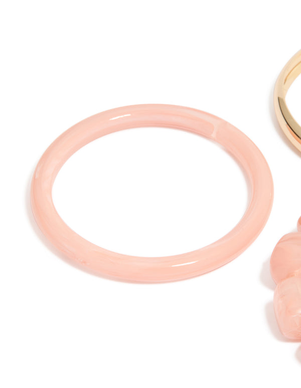 Featuring pink acrylic and gold smooth bangles 3-pack with beaded bracelet detail in close up view