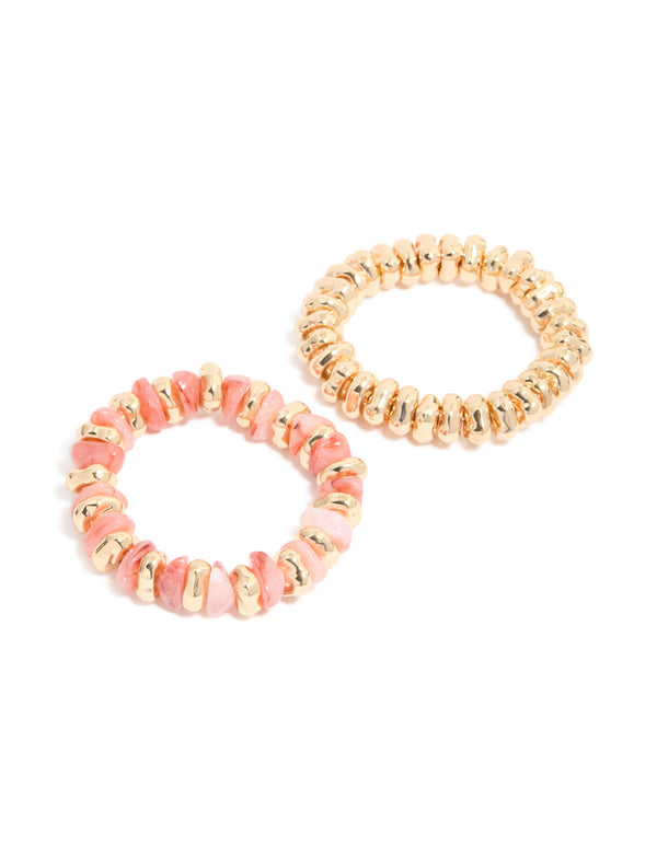 Showcasing beaded stretch bracelets in a 2-pack featuring gold and pink tones in front view