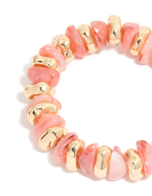 Showcasing beaded stretch bracelets in a 2-pack with gold and pink accents in close up view