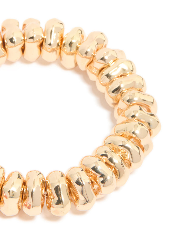 Showcasing beaded stretch bracelets in a 2-pack with gold and pink accents in close up view