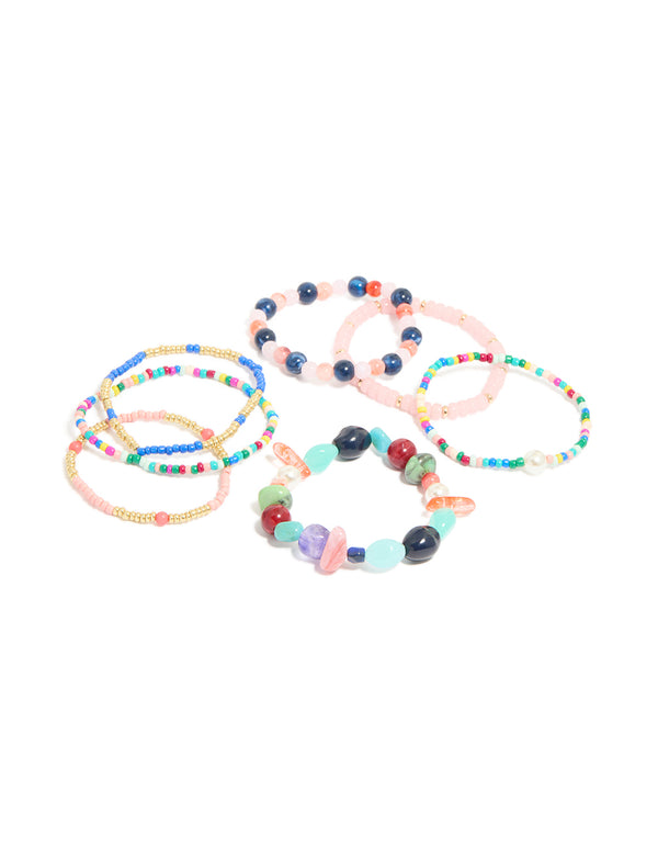 Discover this multicoloured irregular beaded stretch bracelet 7-pack featuring pearl accents in light pink, turquoise, navy and gold in front view