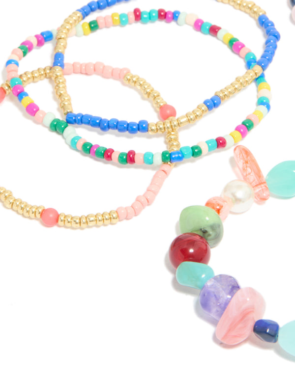 Featuring multicoloured irregular beaded stretch bracelets in a 7-pack with pearl details and light pink, turquoise, navy and gold tones in close up view