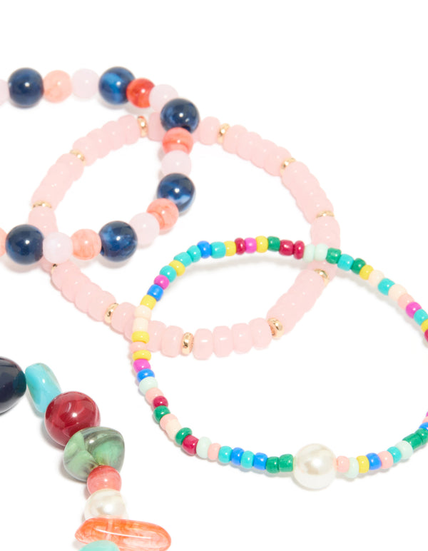 Featuring multicoloured irregular beaded stretch bracelets in a 7-pack with pearl details and light pink, turquoise, navy and gold tones in close up view