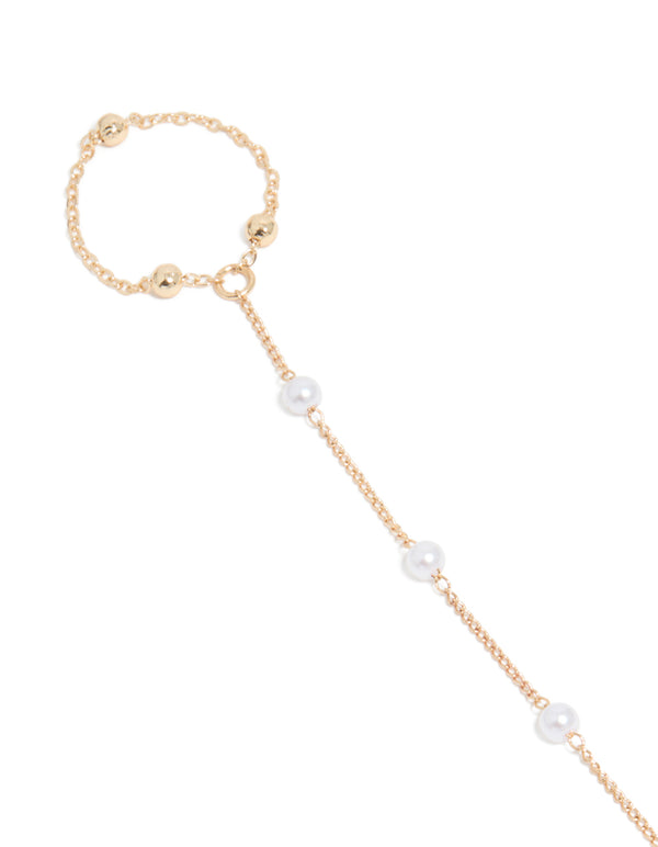 Explore this dainty gold pearl and ball details hand chain in close up view