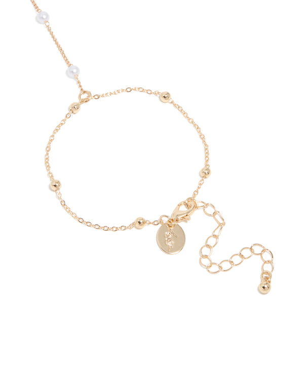 Featuring this dainty gold pearl and ball hand chain and adjustable lock in closure detail view