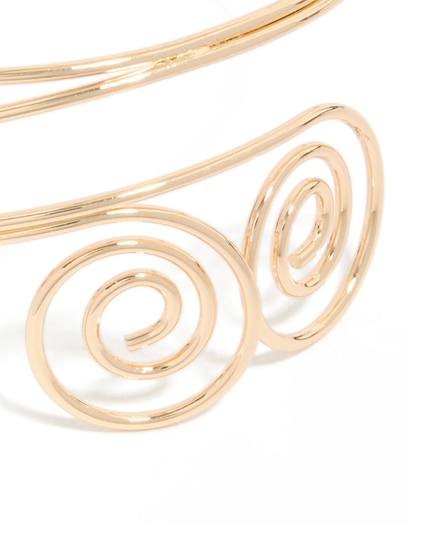 Featuring gold double swirl arm cuff with statement design in close up view