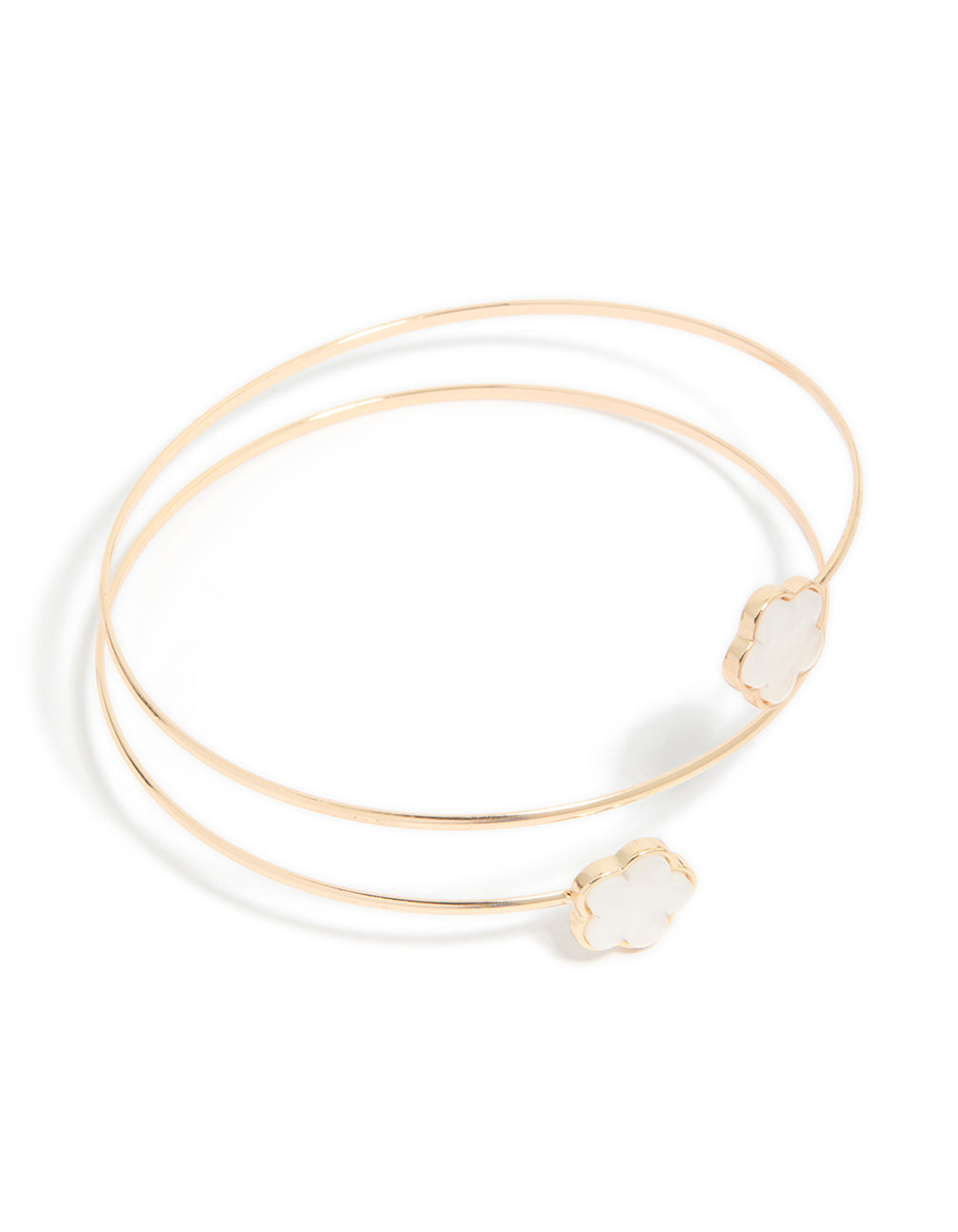 Showcasing a gold small flower arm cuff featuring floral accents in white in front view