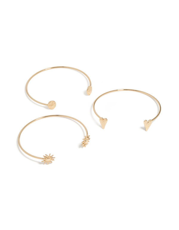 Showcasing gold open mixed designed arm cuffs in a 3-pack featuring celestial and heart details in front view