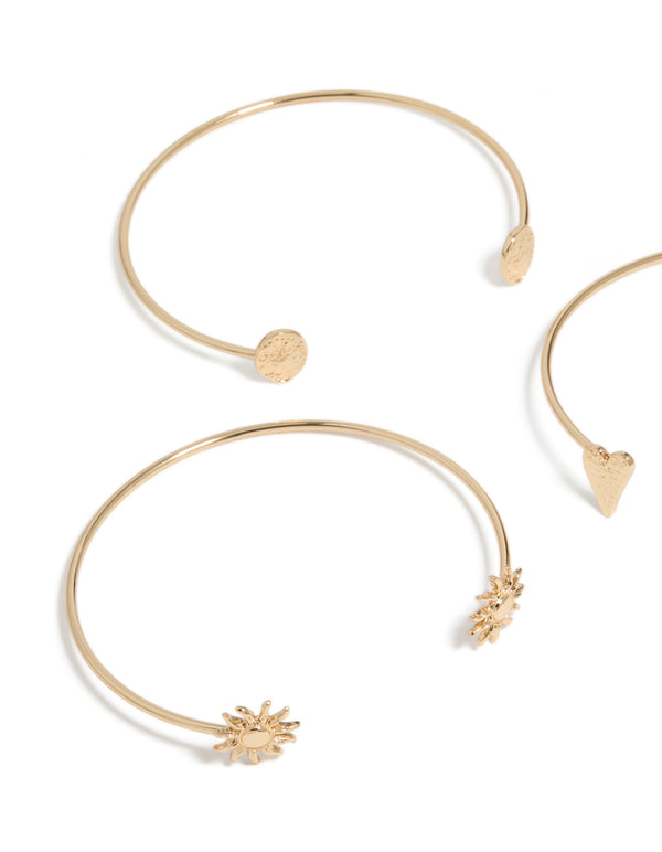 A close look at gold open mixed designed arm cuffs 3-pack with celestial and heart accents in close up view