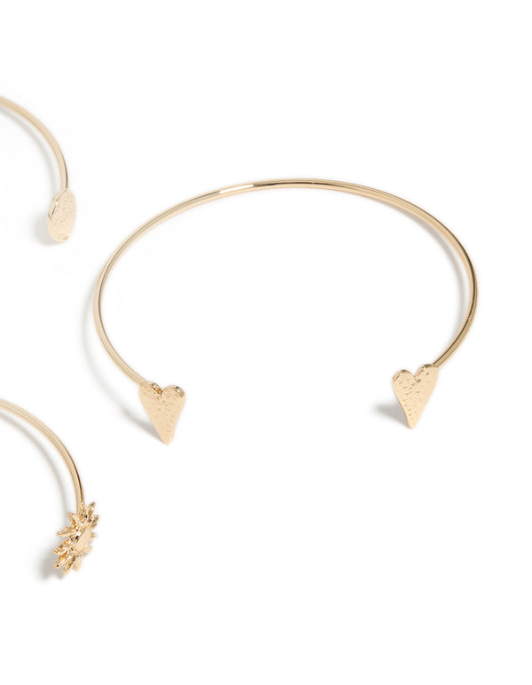 A close look at gold open mixed designed arm cuffs 3-pack with celestial and heart accents in close up view