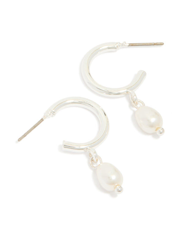 Featuring statement huggie earrings with pearl charm drop in silver front