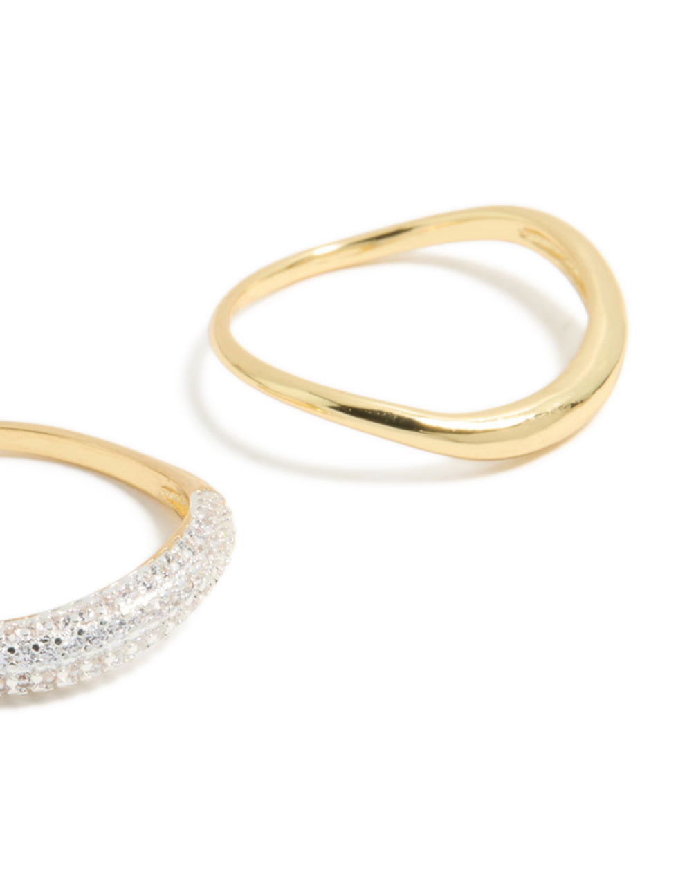 Designed with gold plated simple and wavy cubic zirconia stacking rings in a dainty 2-pack close up view