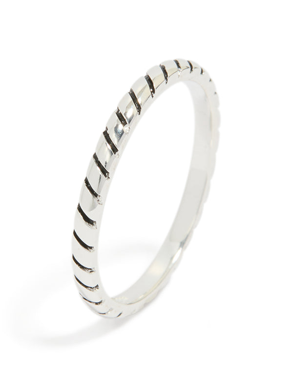 Featuring a textured sterling silver statement ring with black enamel detailing side detail view