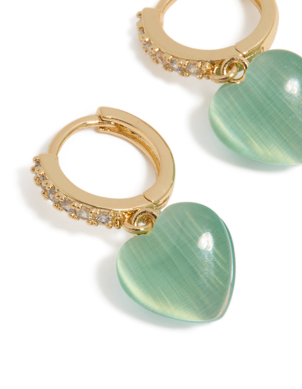 Designed with gold plated cubic zirconia pave and green heart charm huggie earrings in close up view