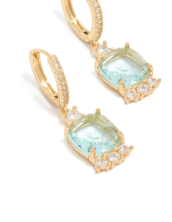 Beautifully crafted gold plated blue square cubic zirconia huggie earrings in aqua and clear stone close up view