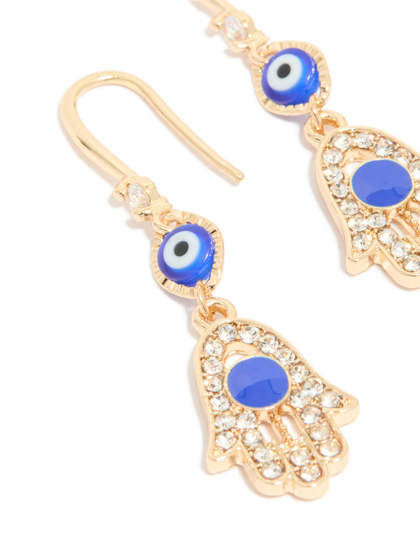 Detailed view of gold cubic zirconia evil eye and hamsa hand drop earrings featuring charm, royal blue, white, and black close up view
