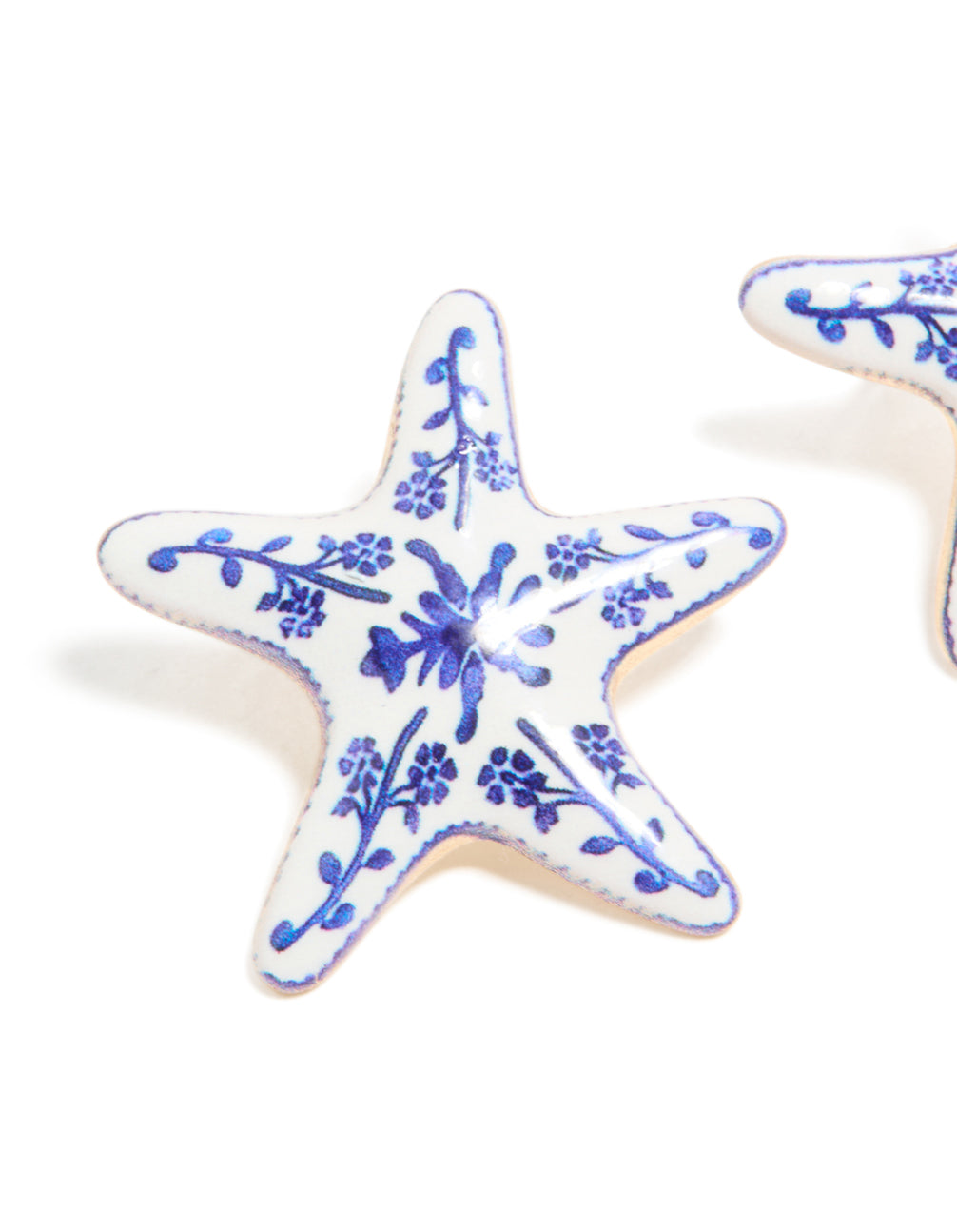 Crafted with painted starfish stud earrings showcasing floral and ocean details in white and blue close up view