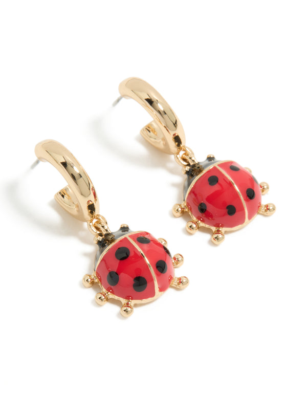 Discover gold ladybug huggie earrings featuring with red and black detailing front view