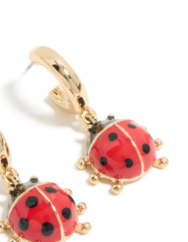 Shop gold ladybug huggie earrings featuring red and black accents post detail view