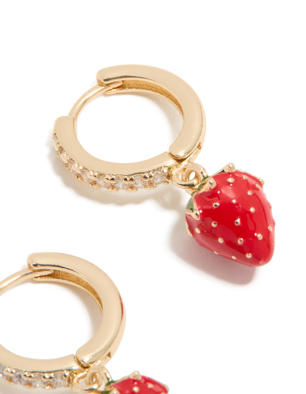 Designed with gold cubic zirconia, these strawberry huggie earrings showcase fruit elements in red, green, and white on ear view