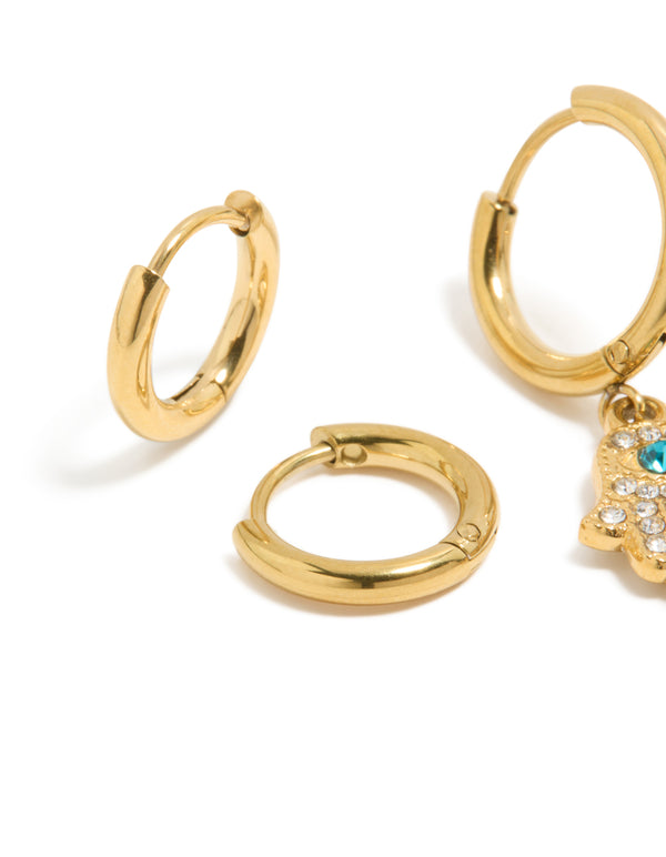 Designed with waterproof gold plated stainless steel evil eye hamsa hand diamante huggie earrings in a 2-pack with turquoise and clear accents close up view
