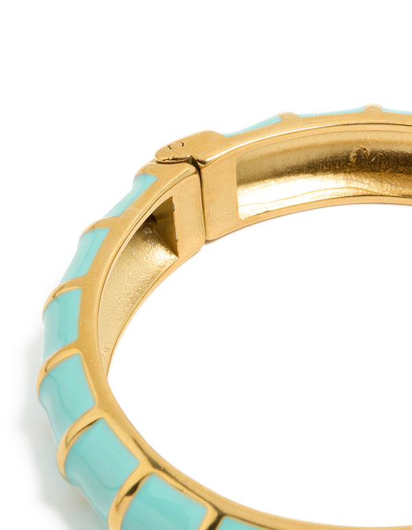 Highlighting this waterproof ribbed blue enamel bangle crafted from stainless steel with gold plating closure detail view