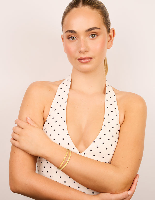Designed with waterproof gold plated stainless steel split double layered wrist cuff bracelet in gold on model view