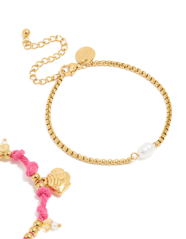 Highlighting waterproof gold plated stainless steel cord bracelets in a 2-pack with ocean charms, beads, rose quartz and freshwater pearl details in pink and white closure detail view