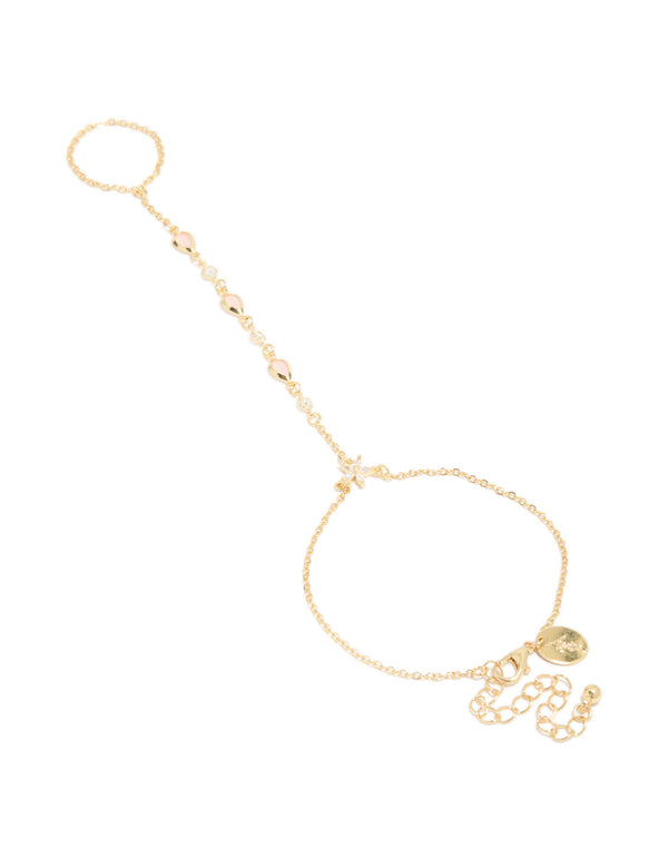 Featuring a gold plated pink cubic zirconia teardrop hand chain bracelet in statement style front view