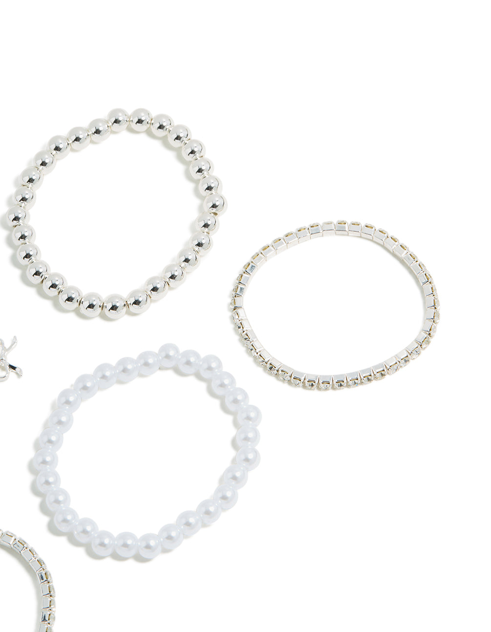 Crafted from beads these kids tennis and pearl bracelets display bow charm details in white and silver side detail view