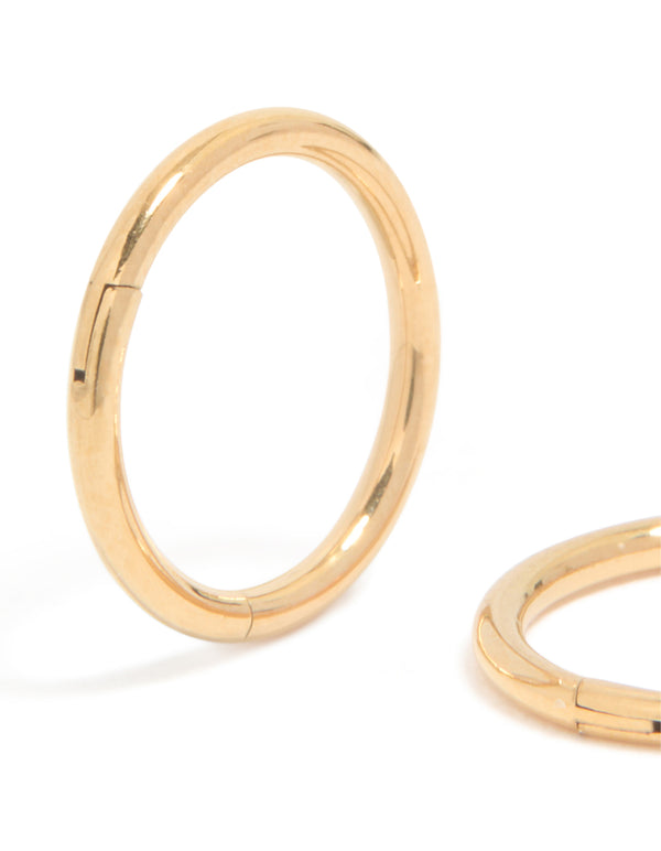 Highlighting chunky hoop sleeper earrings crafted from gold plated titanium close up view