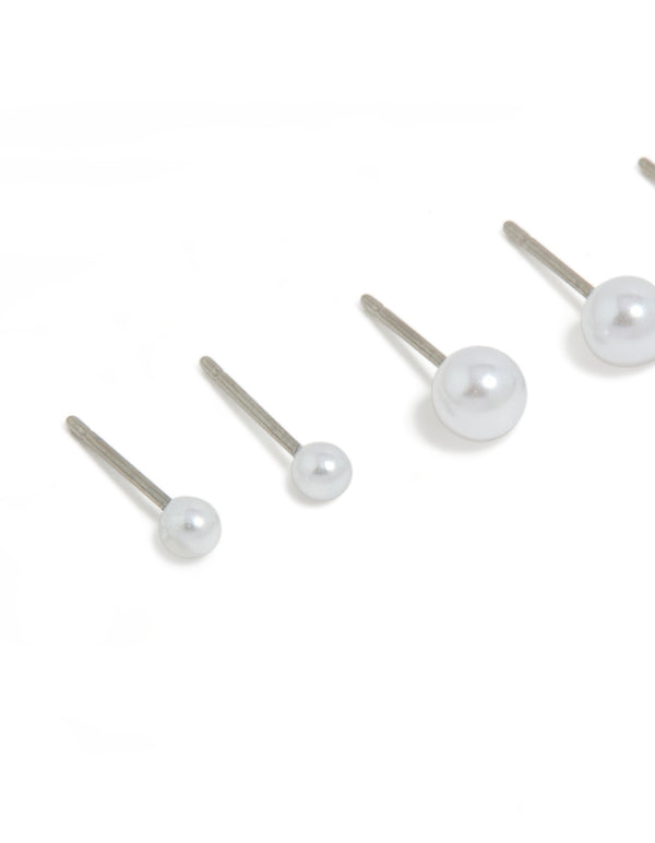 Highlighting surgical steel graduating pearl stud earrings in white and silver with 3-pack close up view