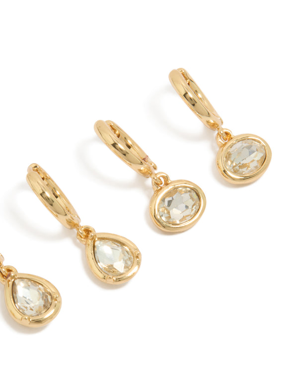 Crafted with large bezel set huggie earrings featuring cubic zirconia and gold plated metal in 3-pack post detail view