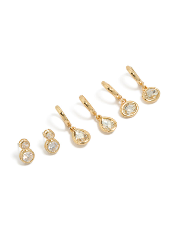 Featuring large bezel set studs and huggie earrings in a 3-pack with cubic zirconia and gold plated finish front view