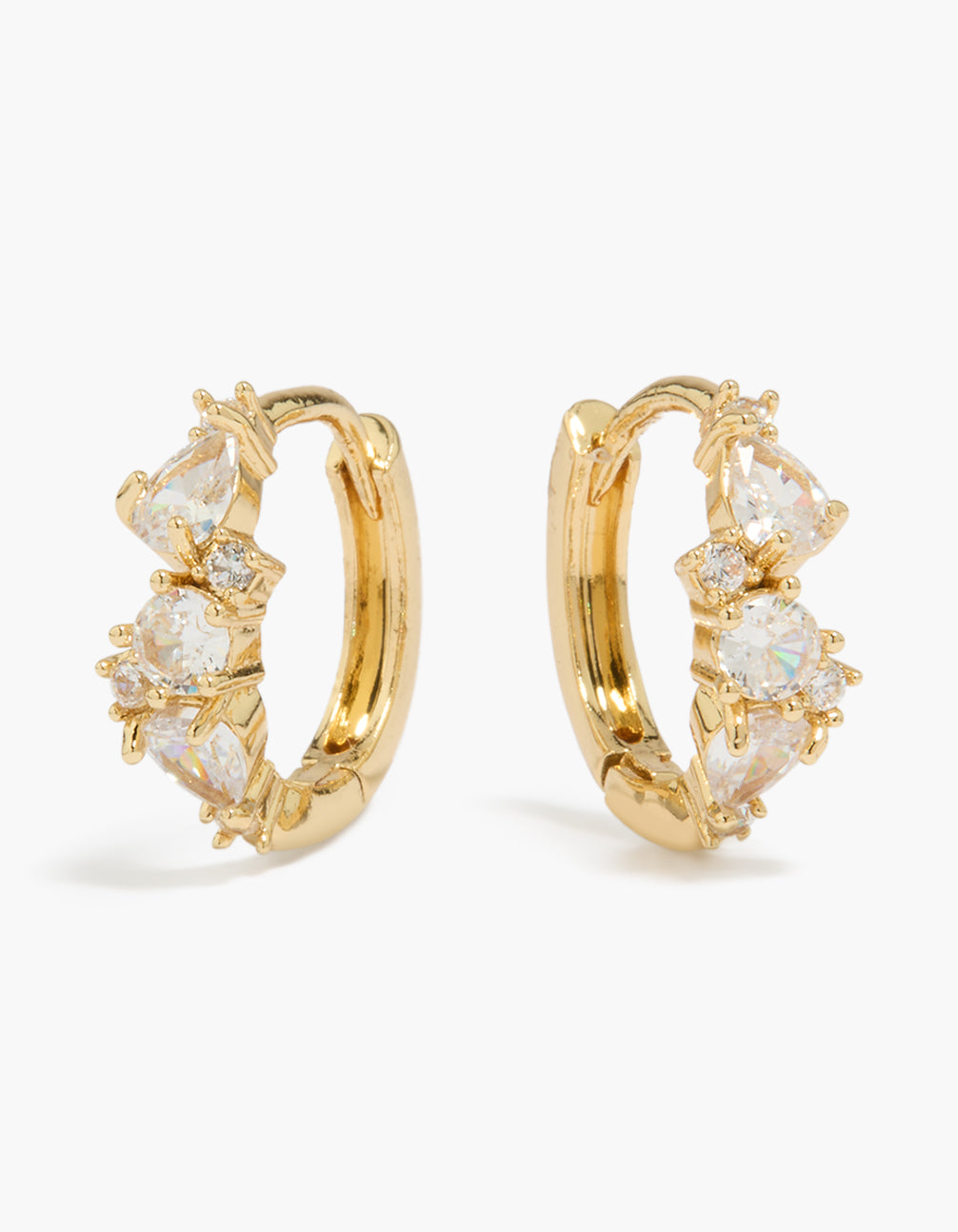 Showcasing gold plated large mixed cubic zirconia huggie earrings with clear accents front view
