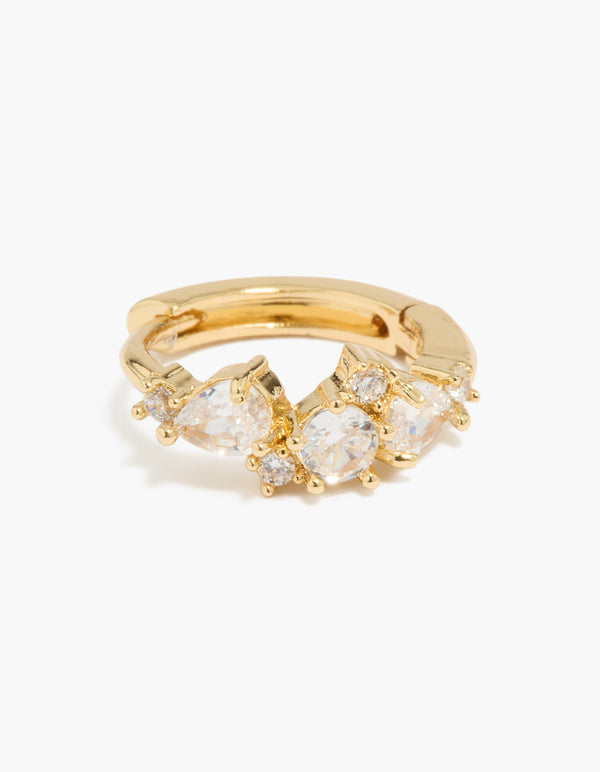 Highlighting gold plated large mixed cubic zirconia huggie earrings with clear accents close up view