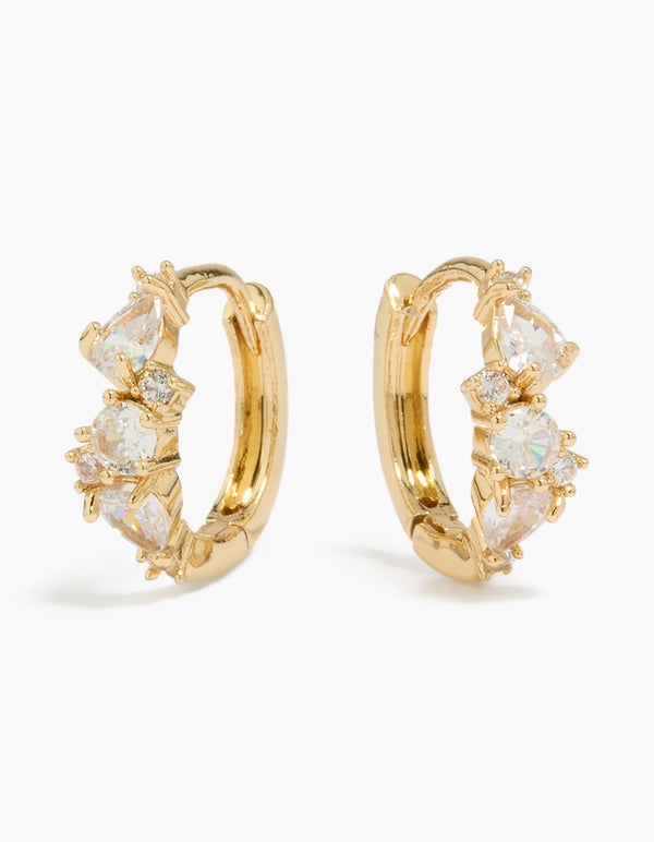 Showcasing gold plated large mixed cubic zirconia huggie earrings with clear accents front view