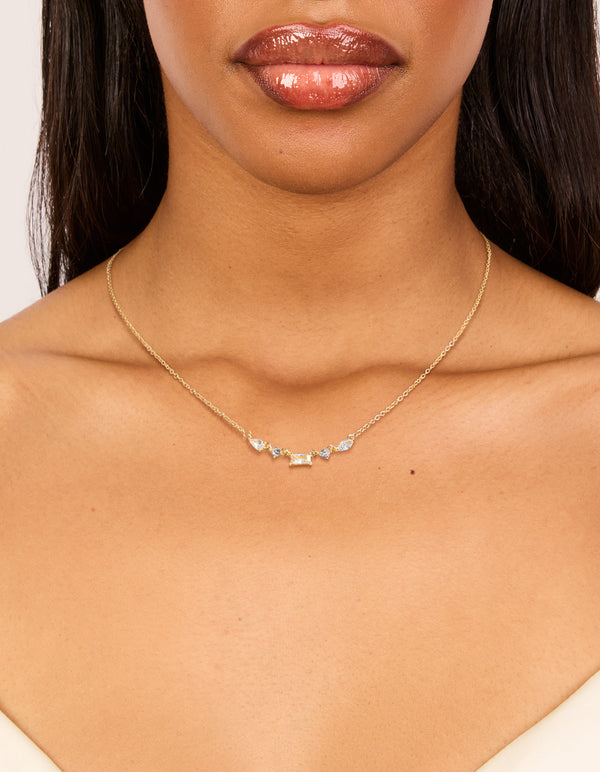 Showcasing a gold plated necklace with mixed shaped cubic zirconia on neck view