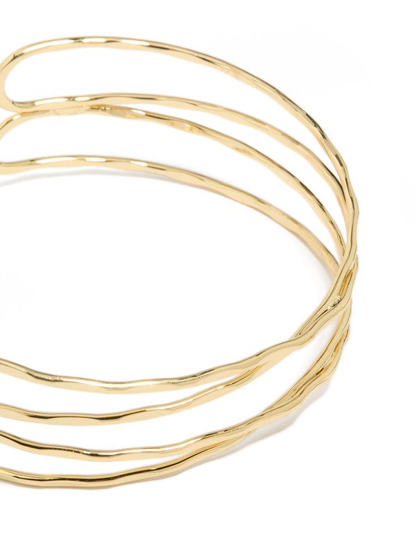 Showcasing gold plated multi cross textured arm cuff with statement design close up view