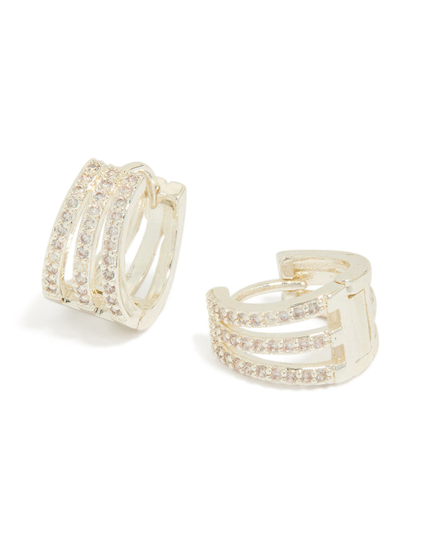 Showcasing trio layered huggie earrings crafted from cubic zirconia in silver plated finish front view