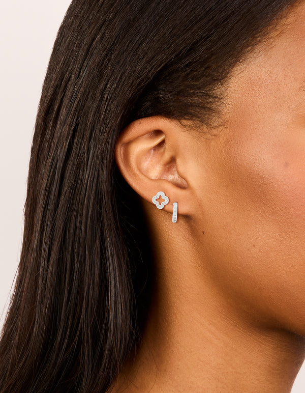 Featuring silver plated cubic zirconia flower stud and huggie earrings 2-pack on ear view