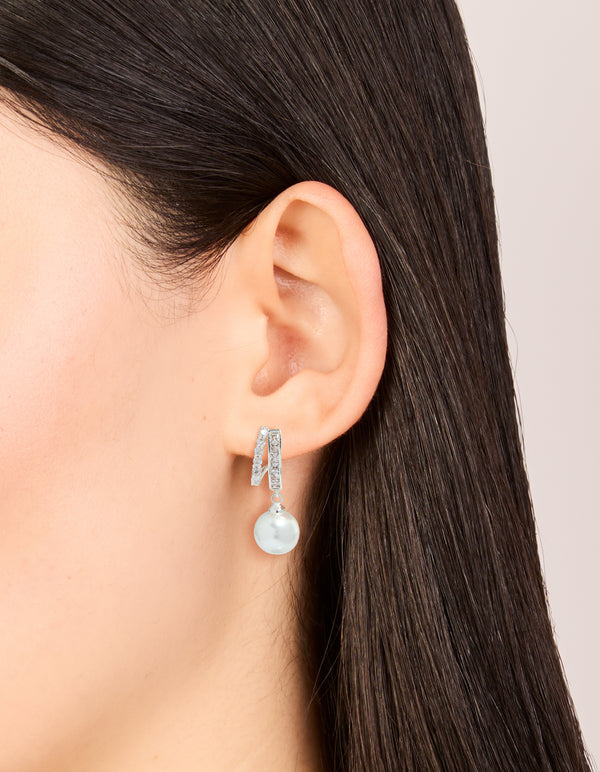 Elegant silver plated cubic zirconia illusion pearl drop earrings with hoop closure on ear view